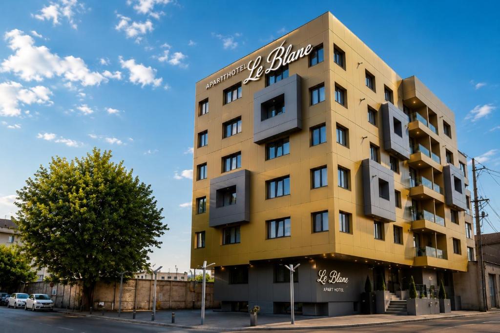a yellow building on the corner of a street at Le Blanc ApartHotel in Bucharest