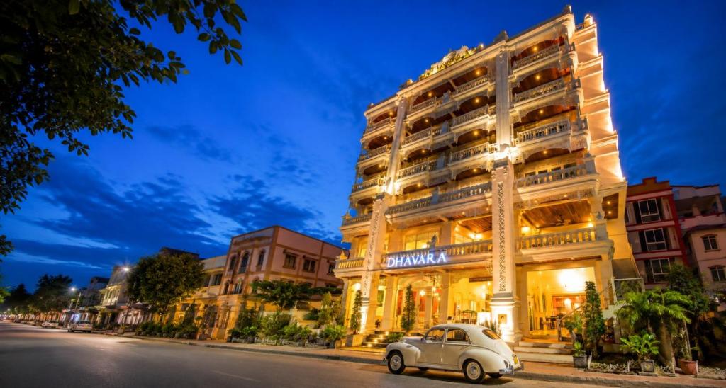 a car parked in front of a large building at Dhavara Boutique Hotel in Vientiane