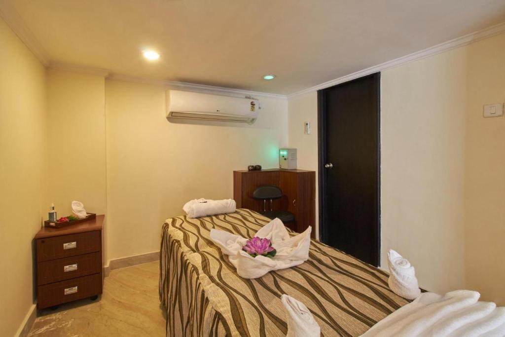 Postel nebo postele na pokoji v ubytování Royal Sarovar Portico Siliguri