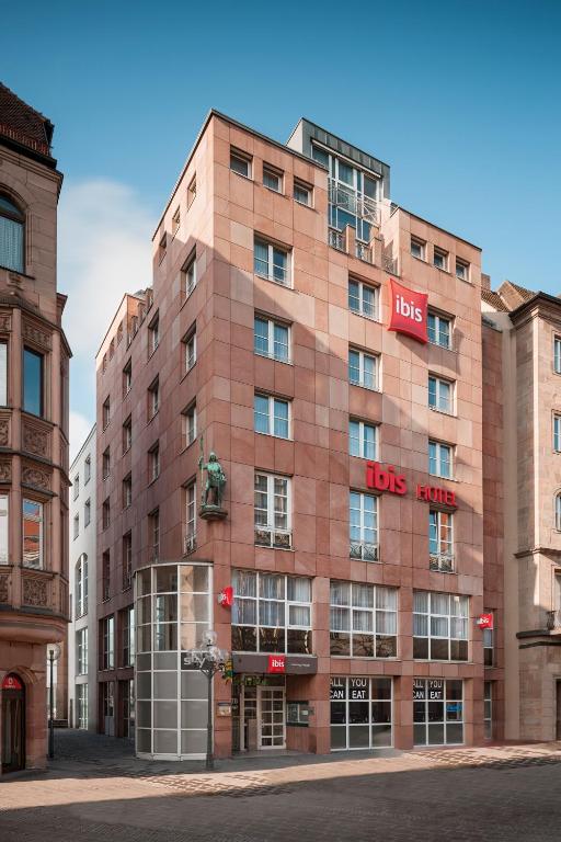 a large brick building with the words lions hotel at ibis Hotel Nürnberg Altstadt in Nuremberg