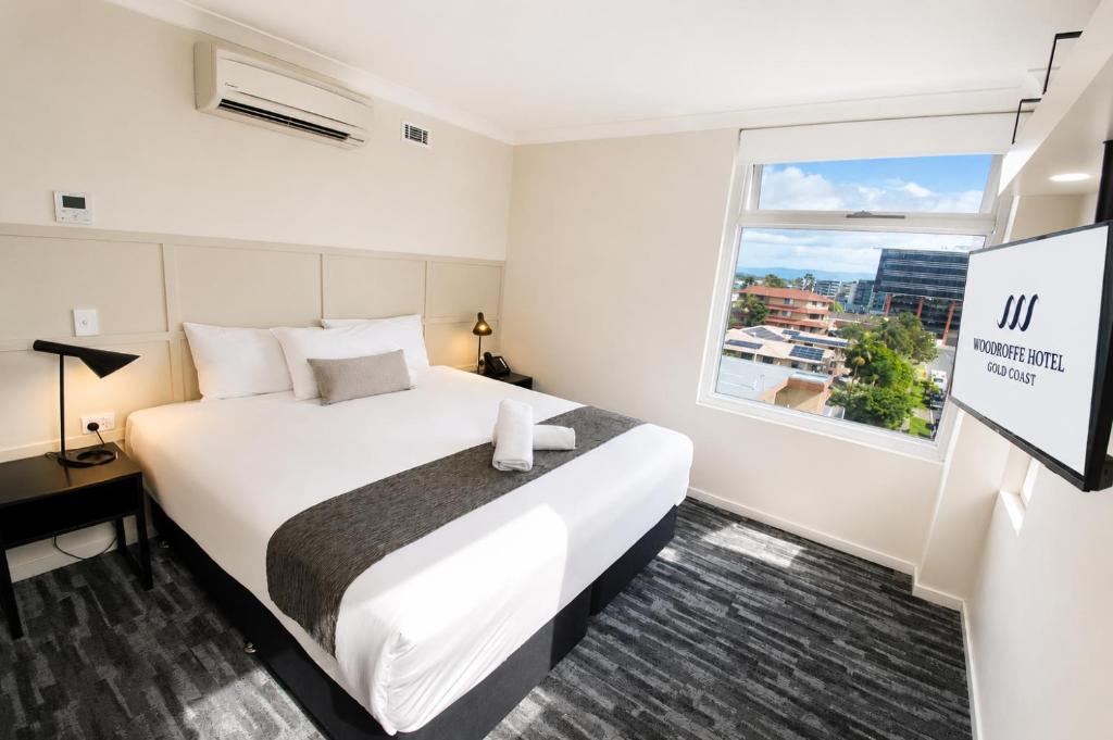 a hotel room with a large bed and a window at Woodroffe Hotel in Gold Coast