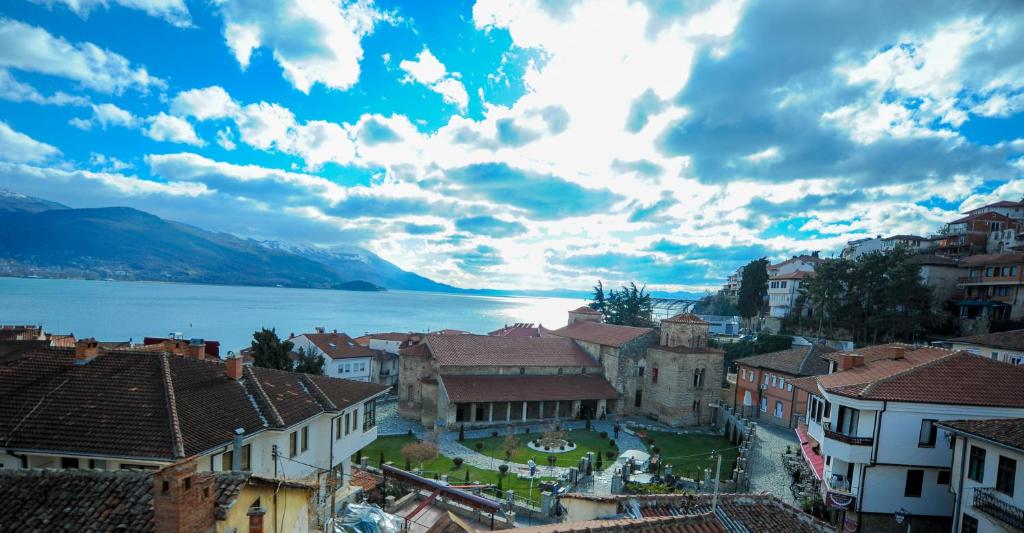 a view of a town with a lake and mountains at Lukanov Apartments & Guest Rooms in Ohrid