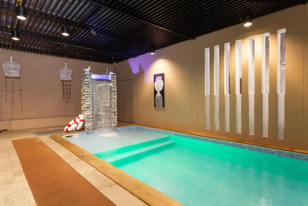 An indoor pool in a softly lit, modern leisure room.