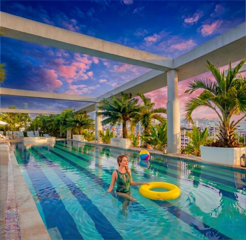 a child playing in the pool at a hotel at FARS Hotel & Resorts - BAR-Buffet-Pool-SPA in Dhaka
