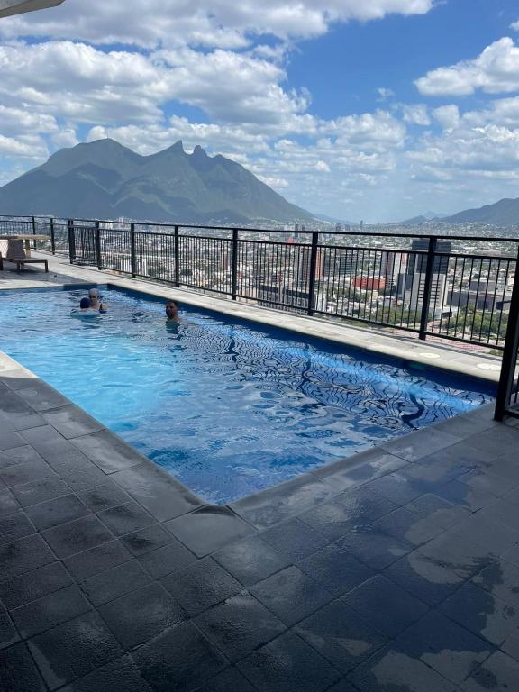 a swimming pool with a view of a mountain at Apartment luxury and comfort in Monterrey