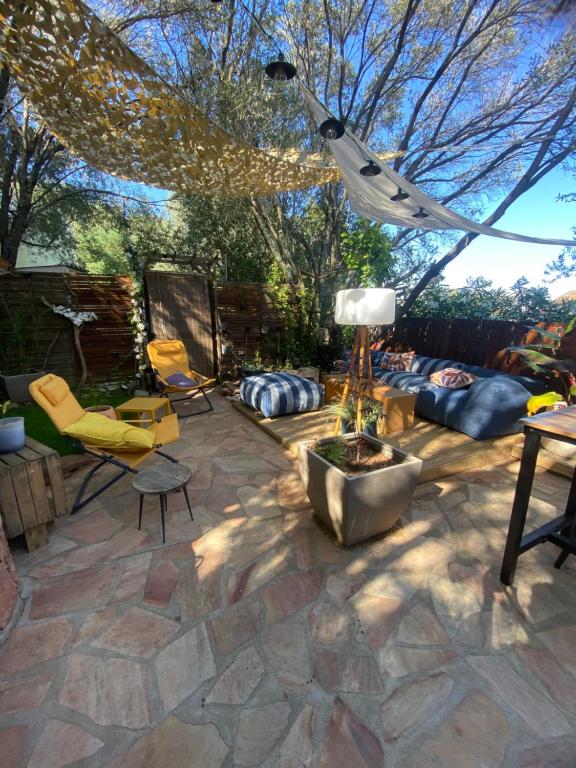 a patio with chairs and a fire pit in a yard at Studio Smart&Cosy in Porto-Vecchio