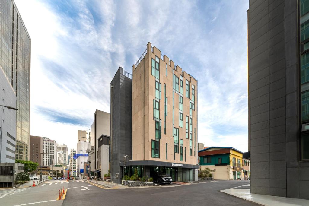 a tall building on a street in a city at Bliss Hotel Myeongdong in Seoul