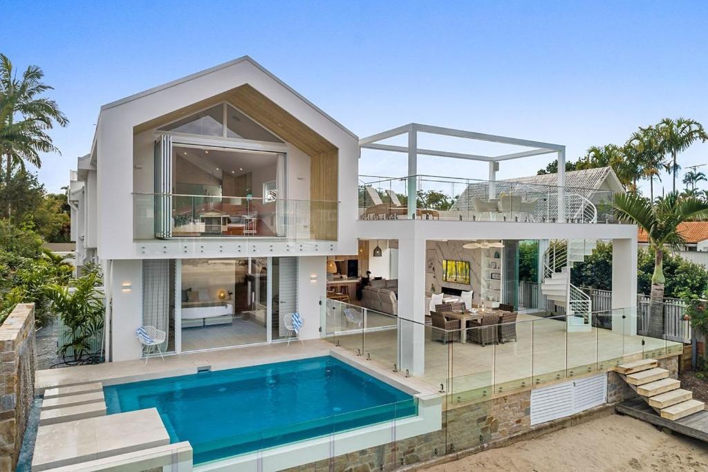 a large house with a swimming pool in front of it at Key Court 17 in Noosa Heads