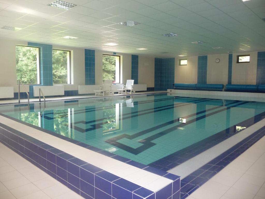 a large swimming pool in a building at Ernesta Club Lipno in Lipno nad Vltavou