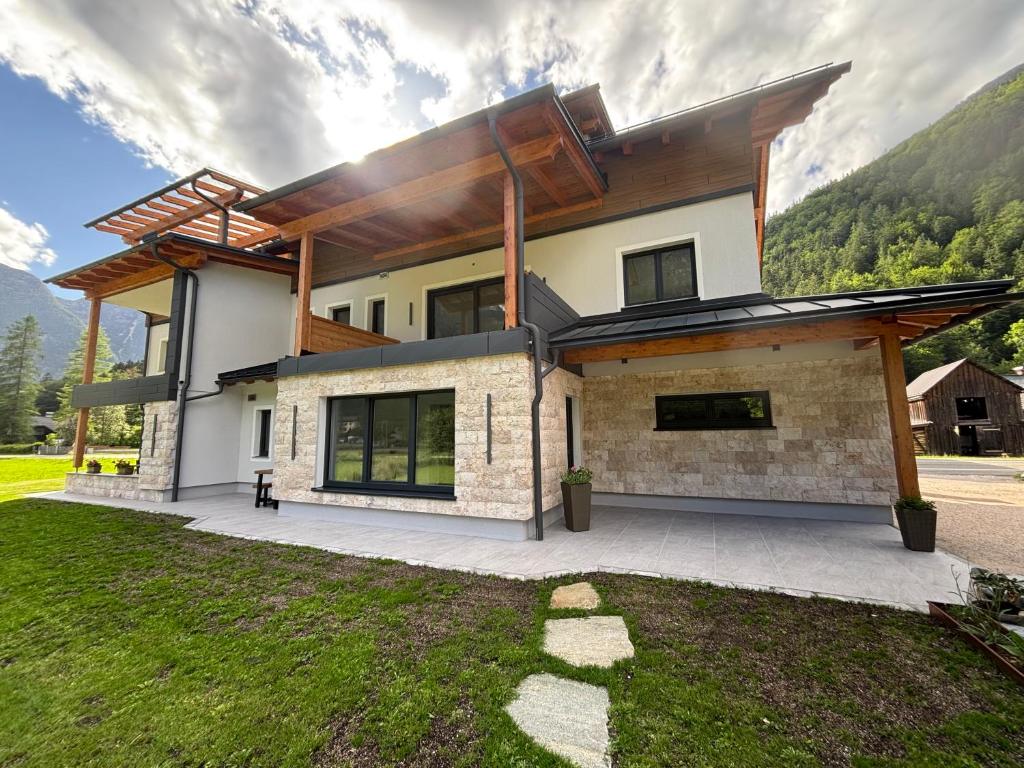 a house with a mountain in the background at Haischberger Apartments in Obertraun