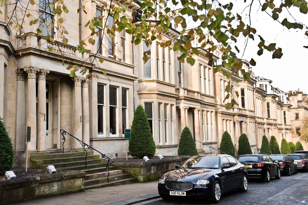 a black car parked in front of a building at One Devonshire Gardens a Hotel Du Vin in Glasgow