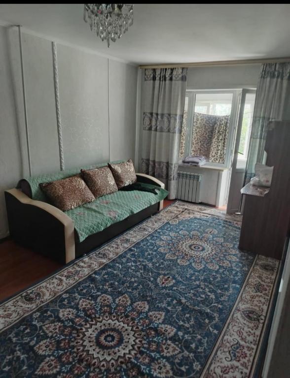 a living room with a couch and a rug at ИП Саялы in Balqash
