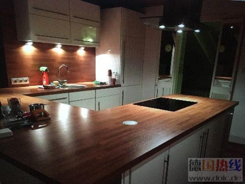 a kitchen with a large wooden counter top at Train Fans in Seevetal