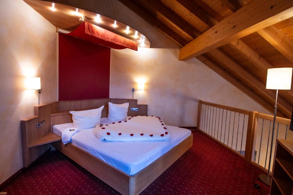 a bedroom with a bed in a attic at Hotel-Restaurant Fröhlich in Kaiserslautern