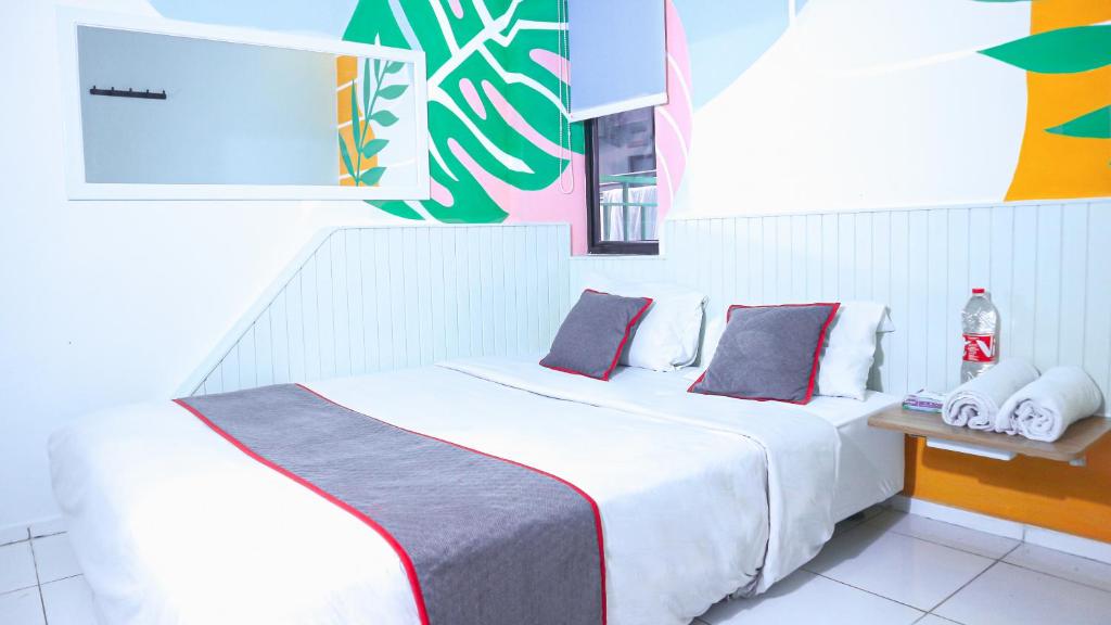 a hotel room with two beds in a room at Artemis Hotel Bekasi in Cikunir Satu