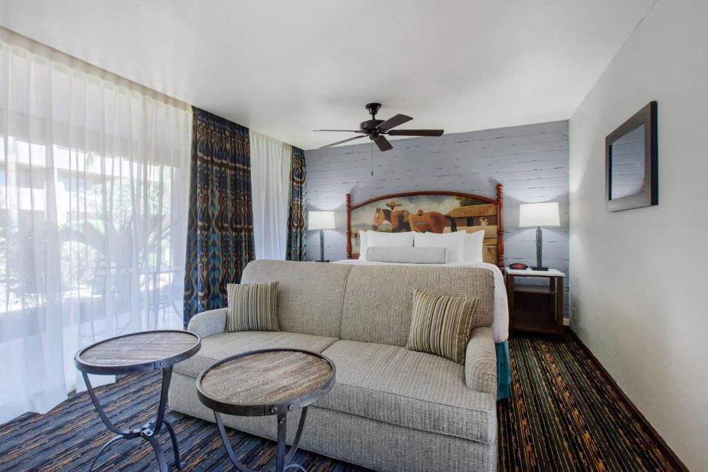 a living room with a couch and a bed at La Posada Lodge & Casitas, an Ascend Collection Hotel in Tucson