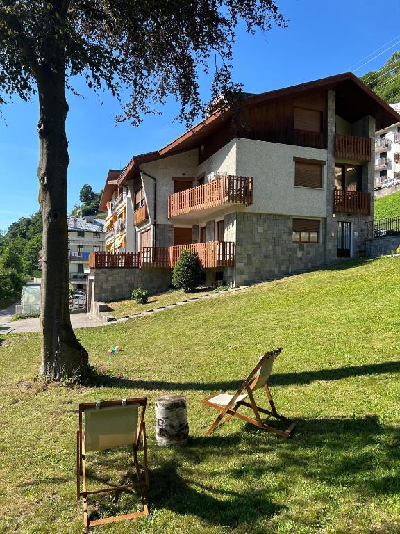 a yard with two chairs in front of a building at B&B Il Faggio Rosso in Vernante