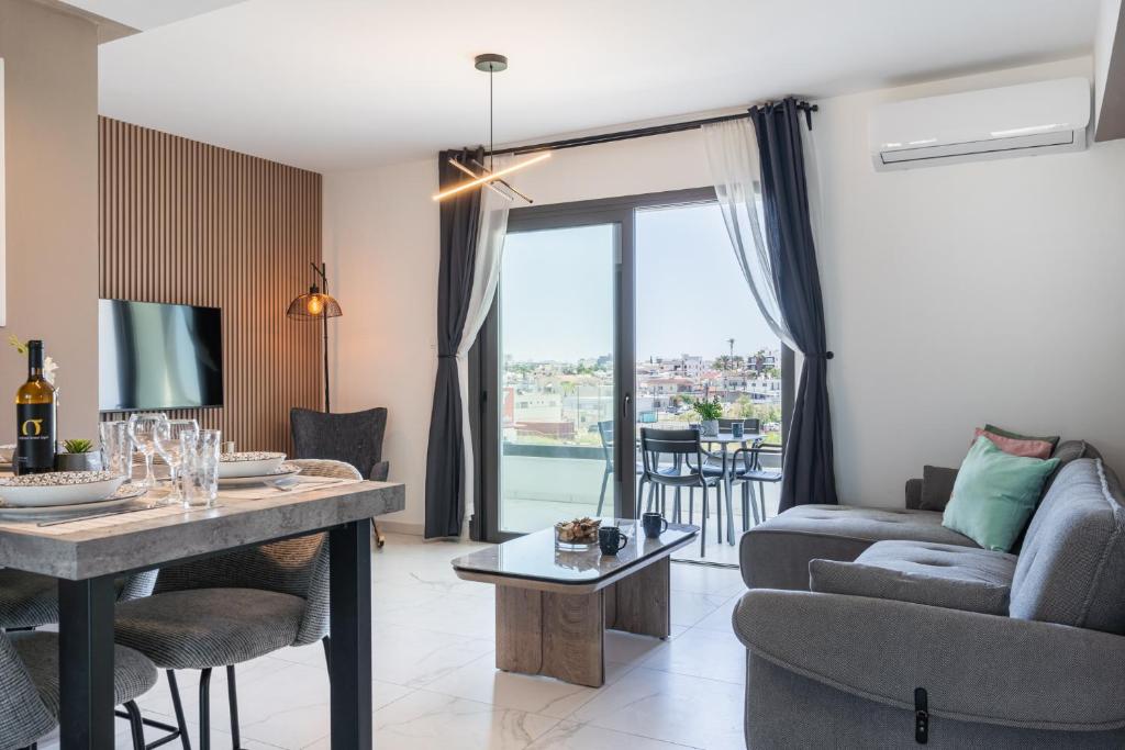 a living room with a couch and a table at Mayan 2-Bedroom Apartment in Larnaca