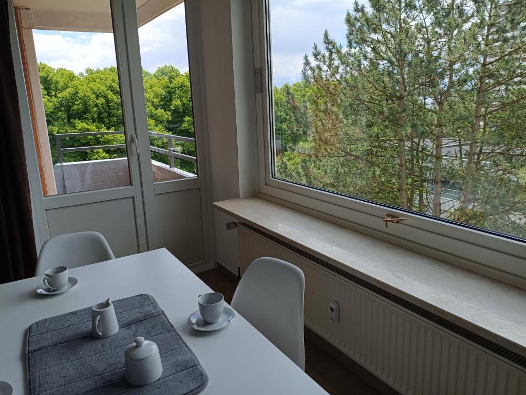 a table and chairs in a room with a window at Westblick in Plön