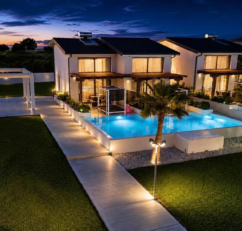 a house with a swimming pool at night at Villa Palma in in Kallithea Halkidikis