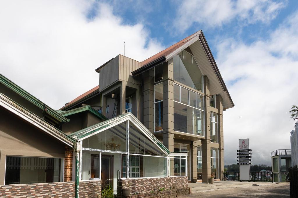 a building with large glass windows on it at Oak Ray Misty Hills in Nuwara Eliya