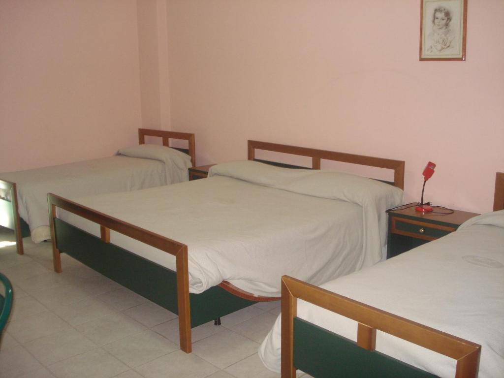 Posteľ alebo postele v izbe v ubytovaní Hotel Grandinetti