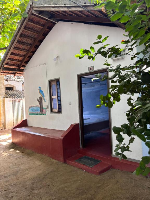 a door to a building with a bench in front at Lime pepper in Pottuvil
