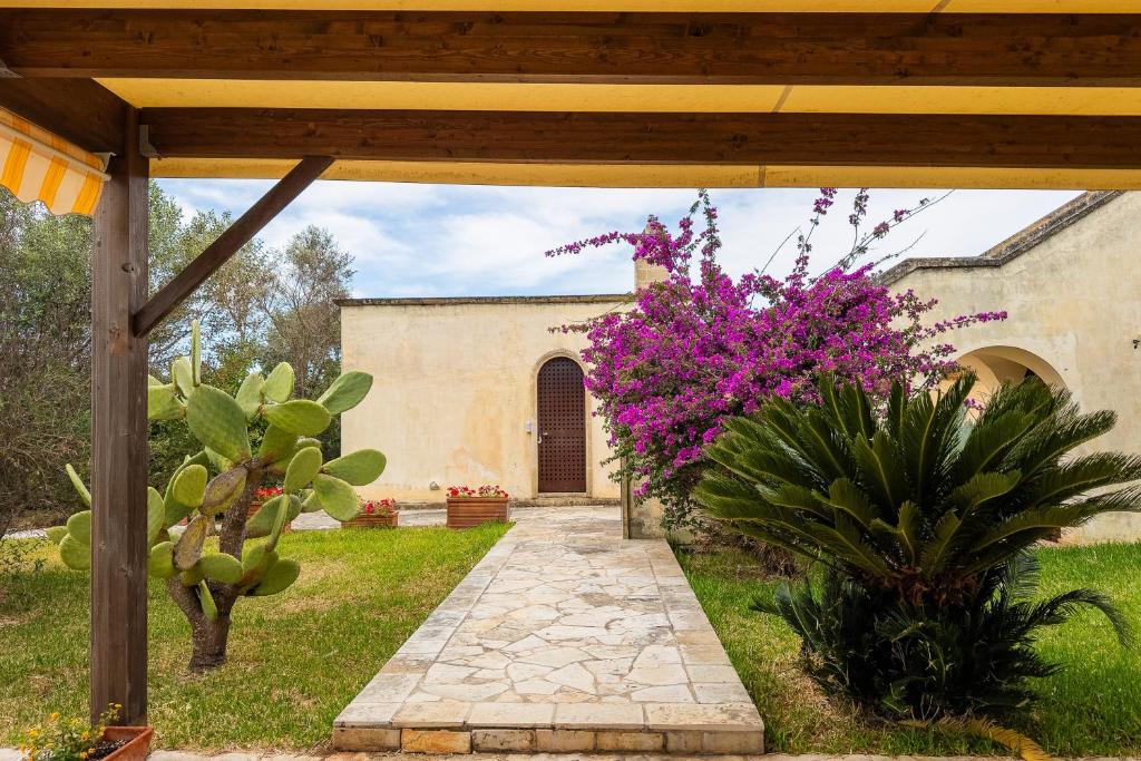 an outside view of a house with pink flowers at Residenze Uliveto - Rooms in Nardò