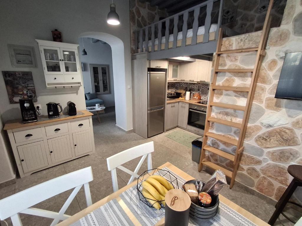 a kitchen with a table with bananas on it at Traditional house in the heart of Naxos in Dhamariónas