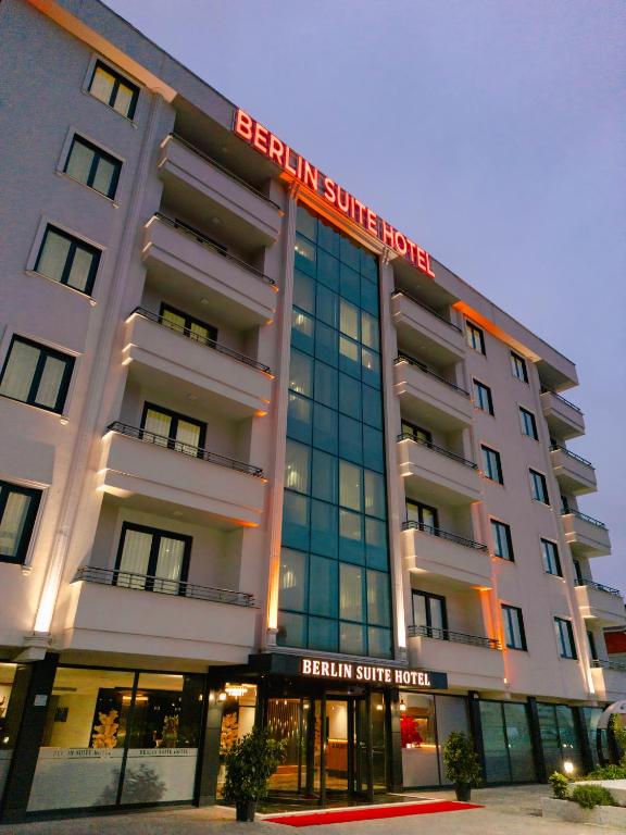 a white hotel with a sign on the front of it at Berlin Suite Hotel Trabzon in Trabzon