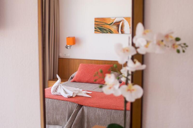 a reflection of a bedroom with a bed in a mirror at Hostal Los Pinos in Es Cana