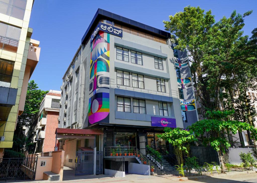 a building with a mural on the side of it at Olive Hotel JP Nagar Metro by Embassy Group in Bangalore