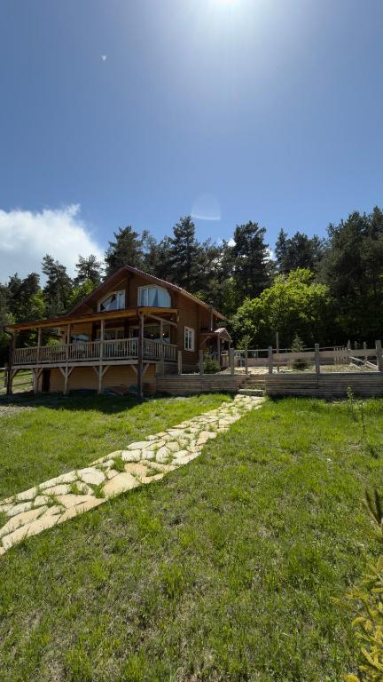 a house with a stone path leading to a house at Birtvisi Dream House in Abrameti