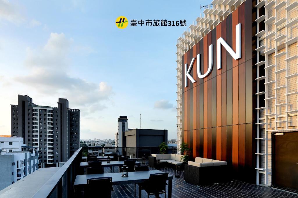 a view of the rooftop of a building with tables and chairs at KUN Hotel in Taichung