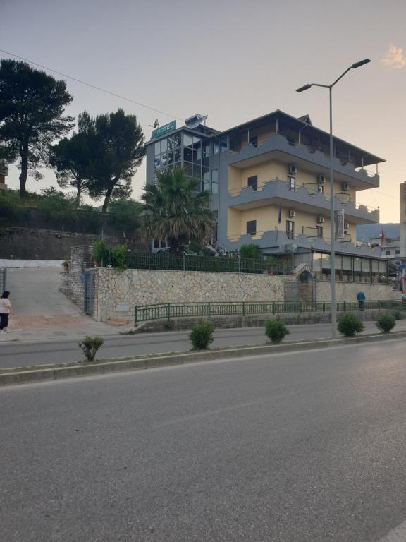 a building on the side of a city street at Qiqi Hotel in Gjirokastër