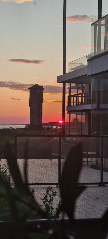 a view of a building with a sunset in the background at Seaside Getaway Apartment in Haapsalu