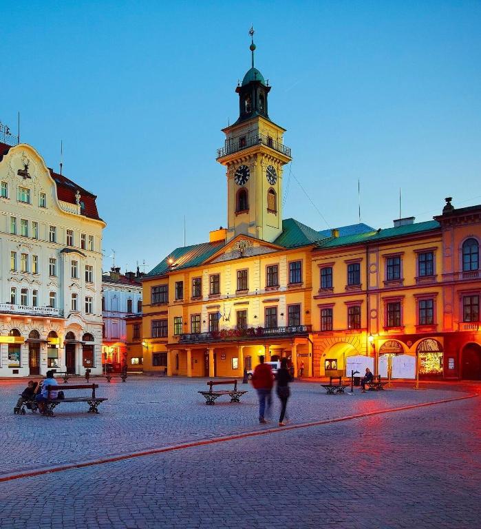 a building with a clock tower on top of it at Cieszyński by Imperis Hotels in Cieszyn