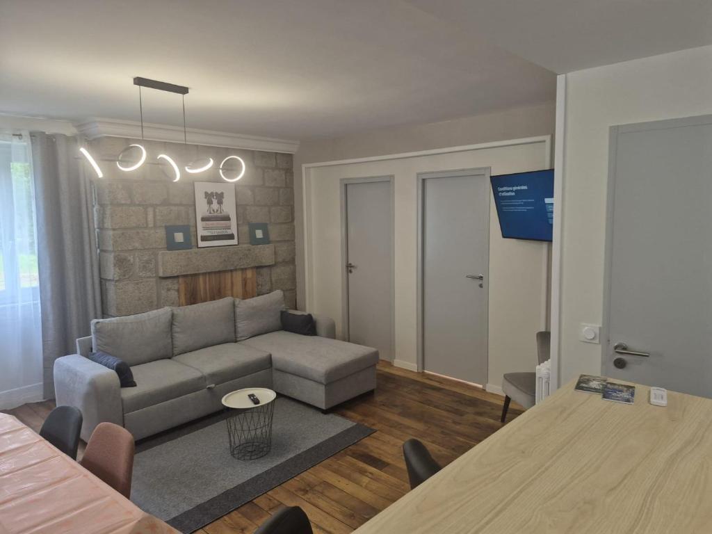 a living room with a couch and a table at Kergoat in Carhaix-Plouguer