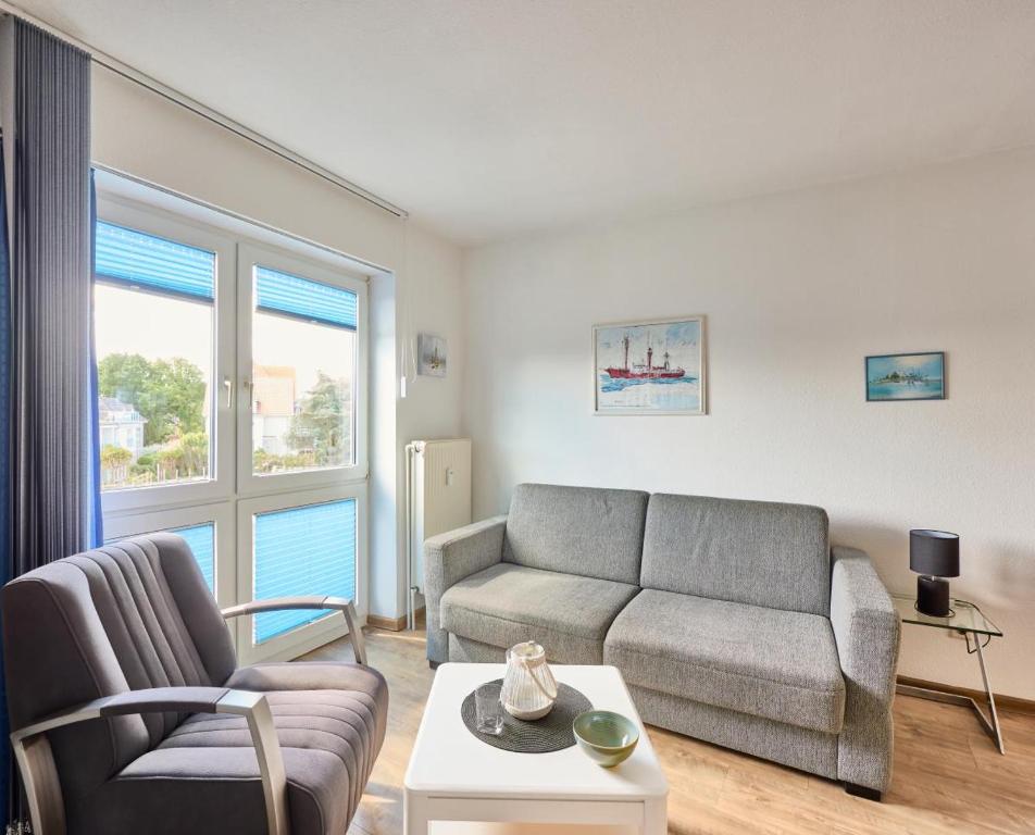 a living room with a couch and a table at Elbe I, Ferienwohnung 29 in Cuxhaven