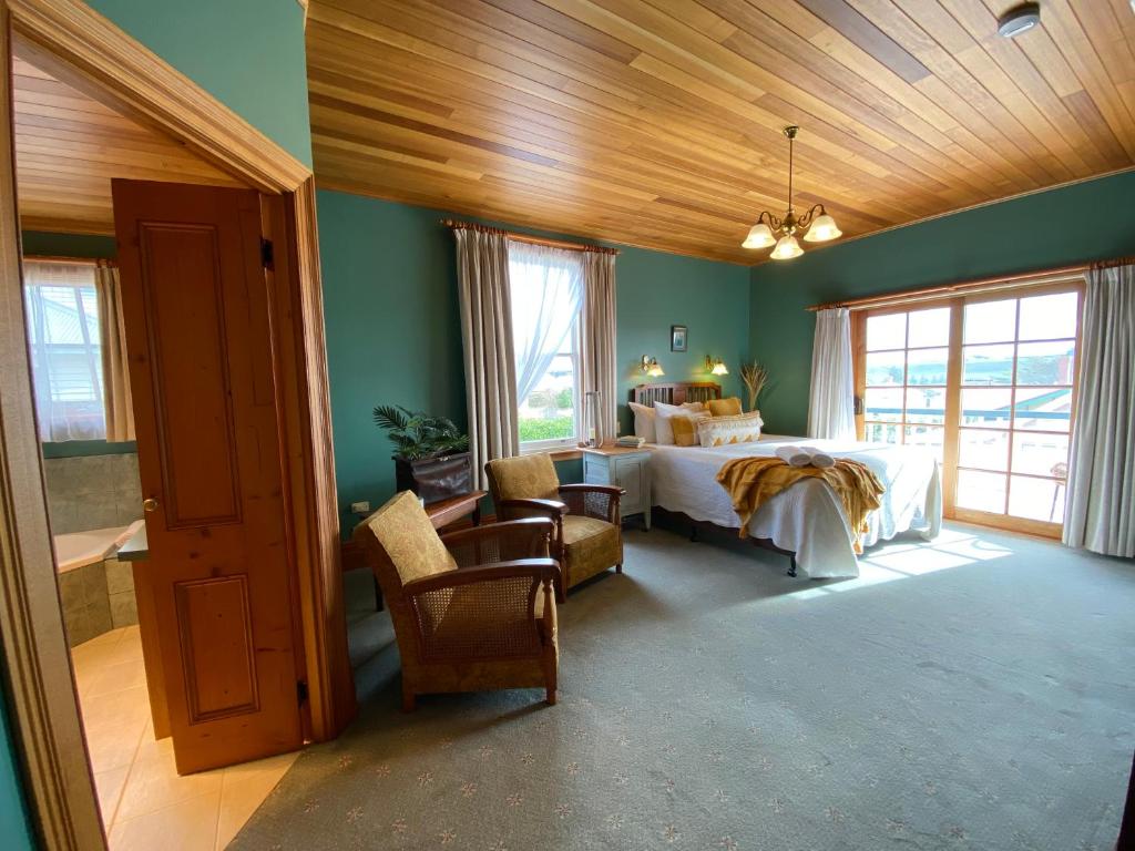 a bedroom with a bed in a room with green walls at Hanlon Guest House in Stanley