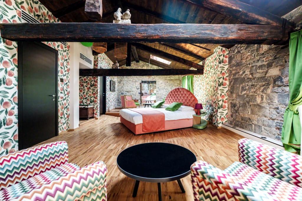 a bedroom with a bed and a table and chairs at Aurum Collection - Como Suites in Como