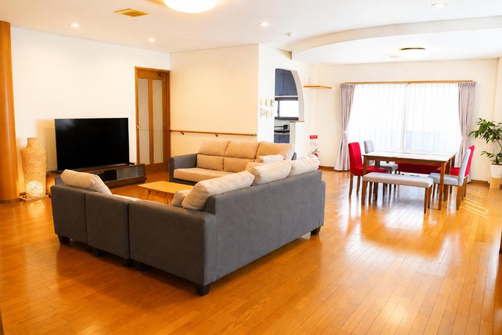 a living room with a couch and a table at Sumomo in Takayama