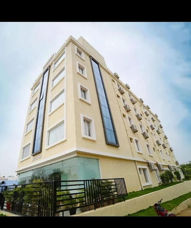a large building with windows on the side of it at Aditya Homes Gachibowli in Hyderabad