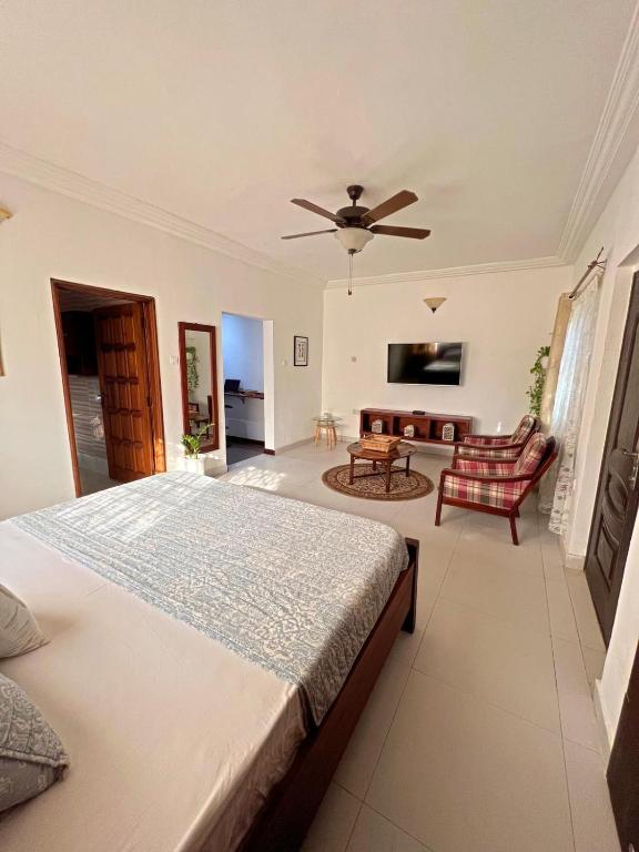 a bedroom with a bed and a living room at Nortram Homes - Adenta in Apenkwa