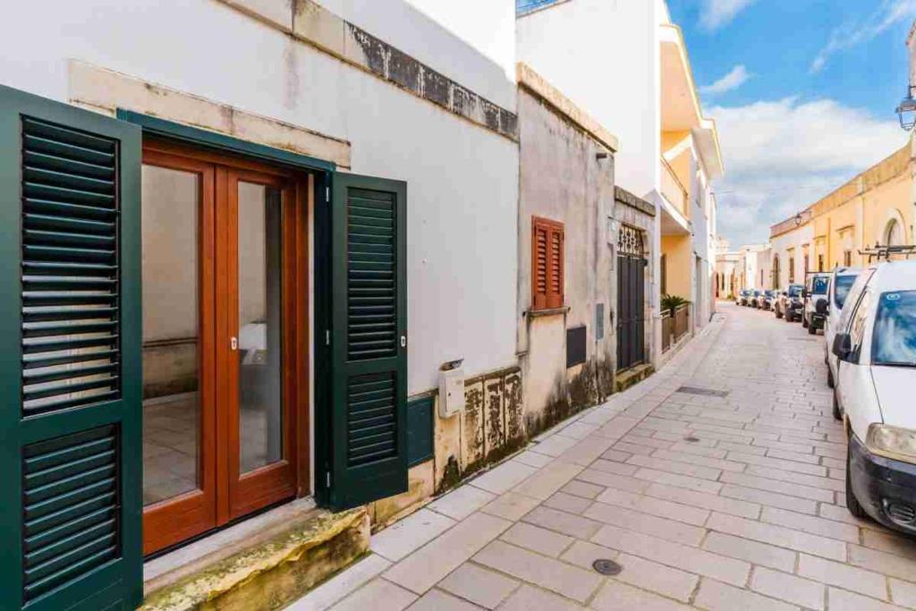 a street with cars parked on the side of a building at SalentoTraTerraMare in Diso