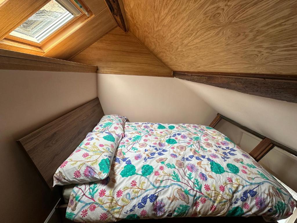 a small bed in a small room with a window at Urban Perch in Penrith
