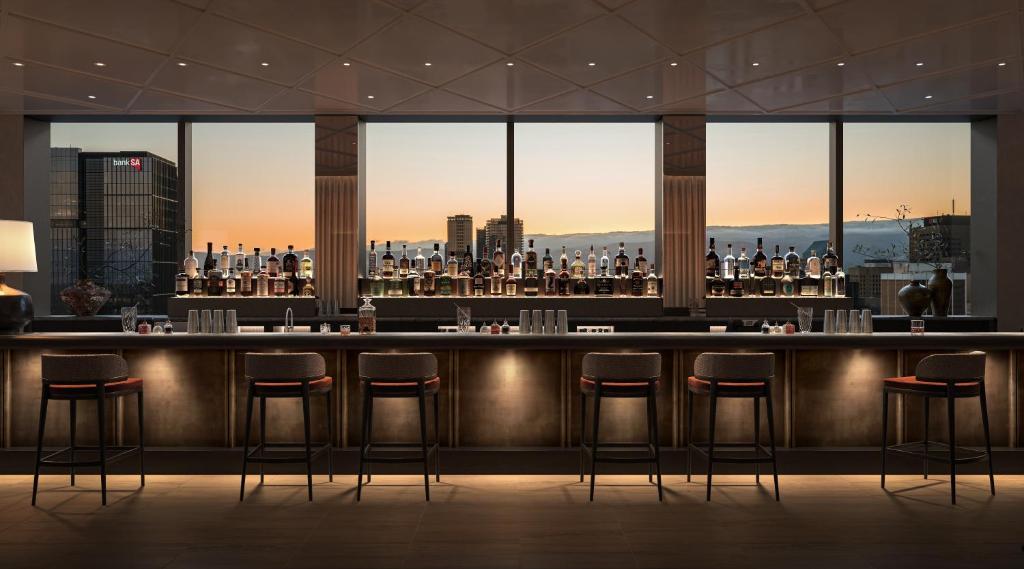 a bar in a building with a view of a city at Little National Hotel Adelaide in Adelaide