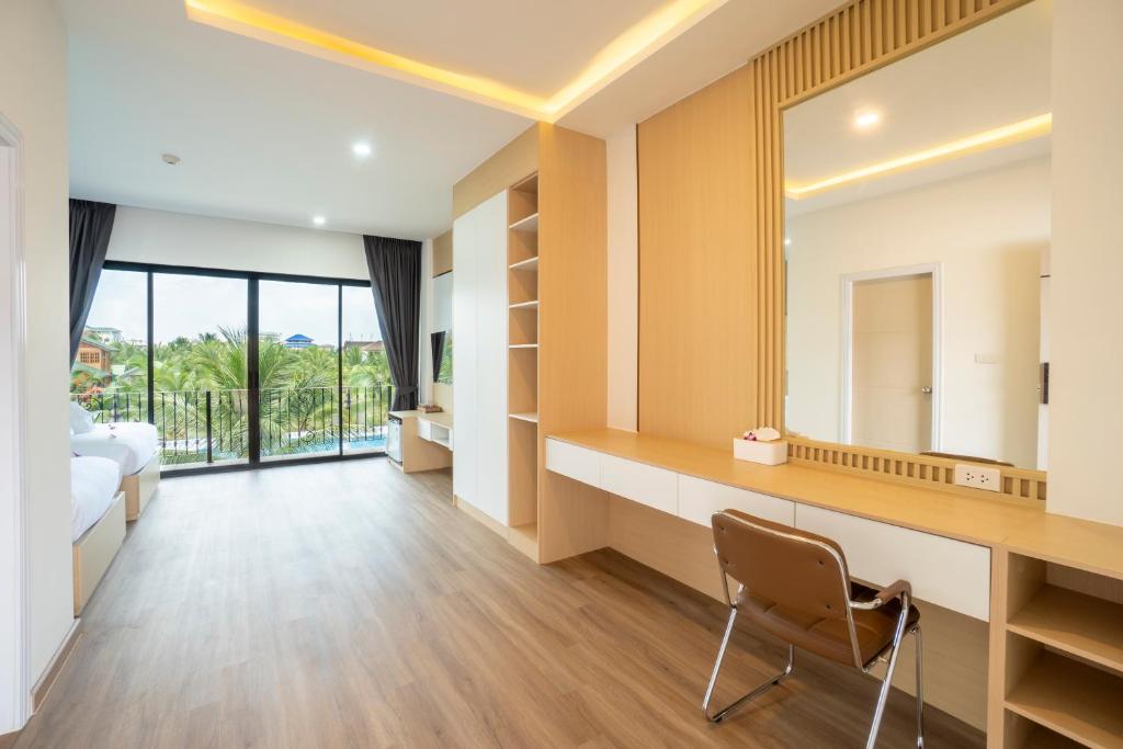 A built-in vanity and desk facing a large window or balcony opening.