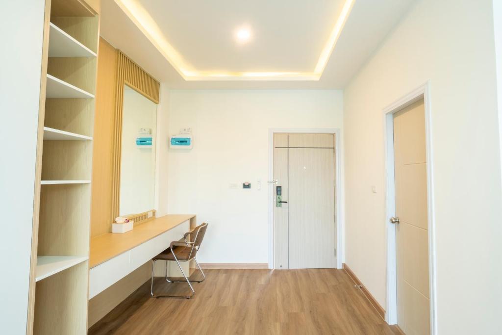 A compact dressing and work area with a built-in desk and open shelving.