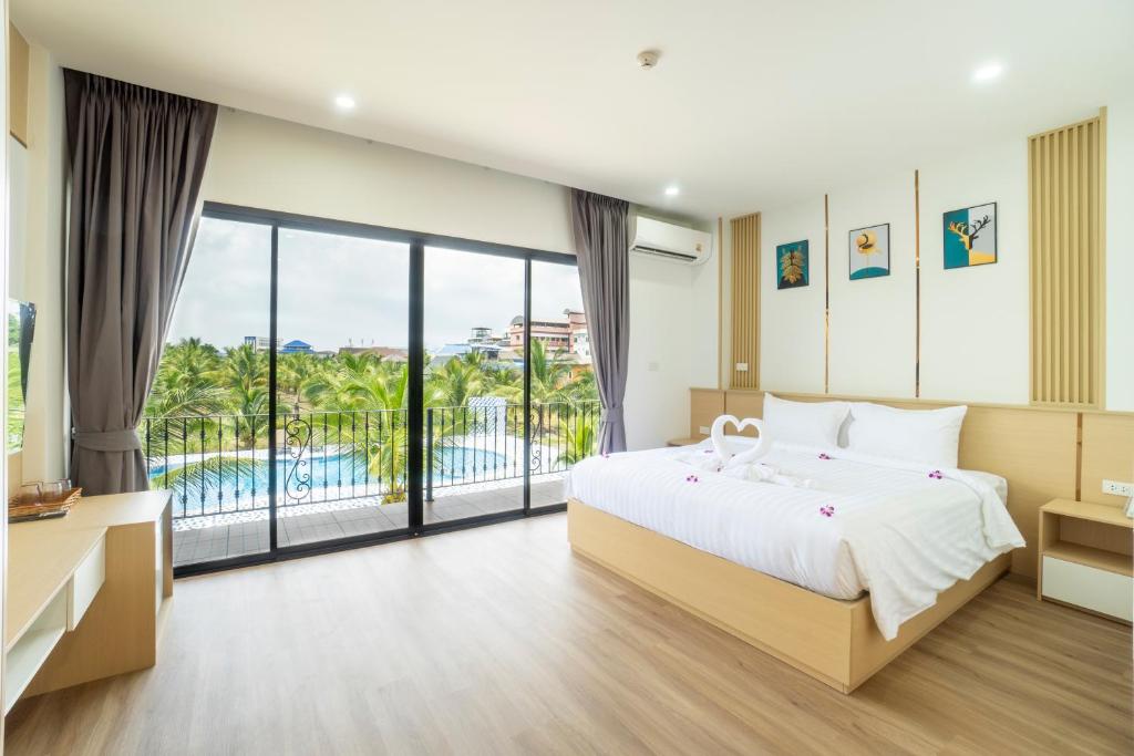 A double room opening onto a pool-facing balcony.